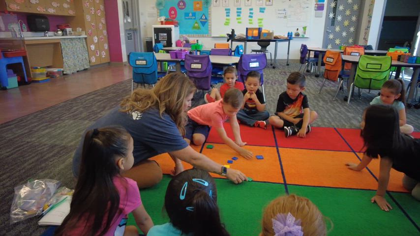 Staff and students enjoying their day at Summerwind Trails School. Students engaged in classroom activities, staff cheering at a House activity, staff welcoming students into classroom. 