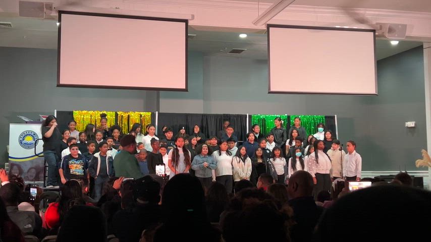 Students signing the wizard of OZ in a chior