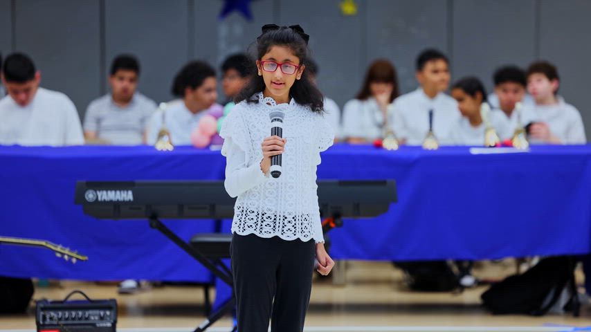 A girl sings in the middle of a gymnasium 