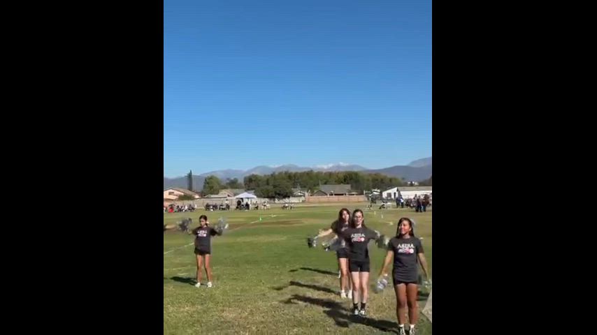 students are performing cheers while others do activities during community event
