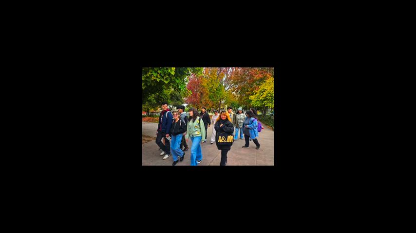 students walkthrough campus in footage 