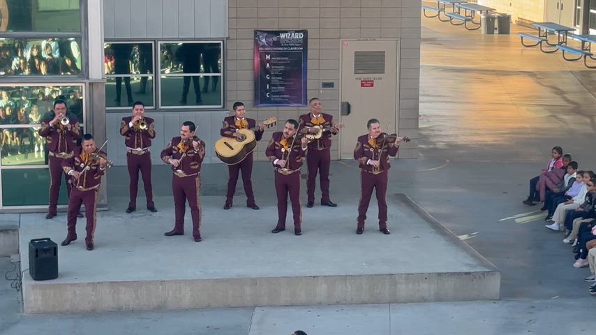 students playing instruments infront of commnunity